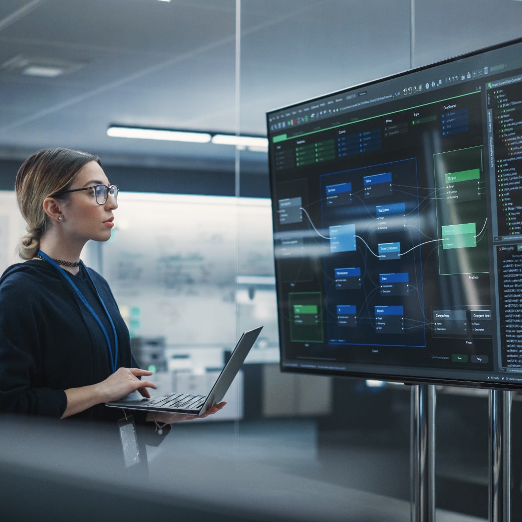 Portrait of a Multiethnic QA Engineer Working on Finding and Fixing Bugs in a Product or Program Software Code Before the Launch. Female Using Laptop Computer, Collaborating with Developers Online