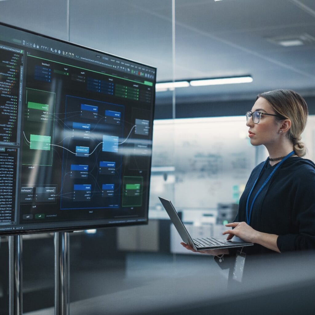 Portrait of a Multiethnic QA Engineer Working on Finding and Fixing Bugs in a Product or Program Software Code Before the Launch. Female Using Laptop Computer, Collaborating with Developers Online